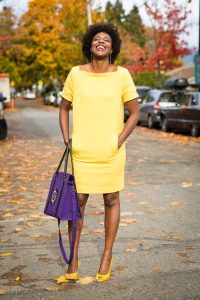 Entrepreneur Jackee Kasandy, with a sample of her bag collection posing for a photo. |Photo| Courtesy|