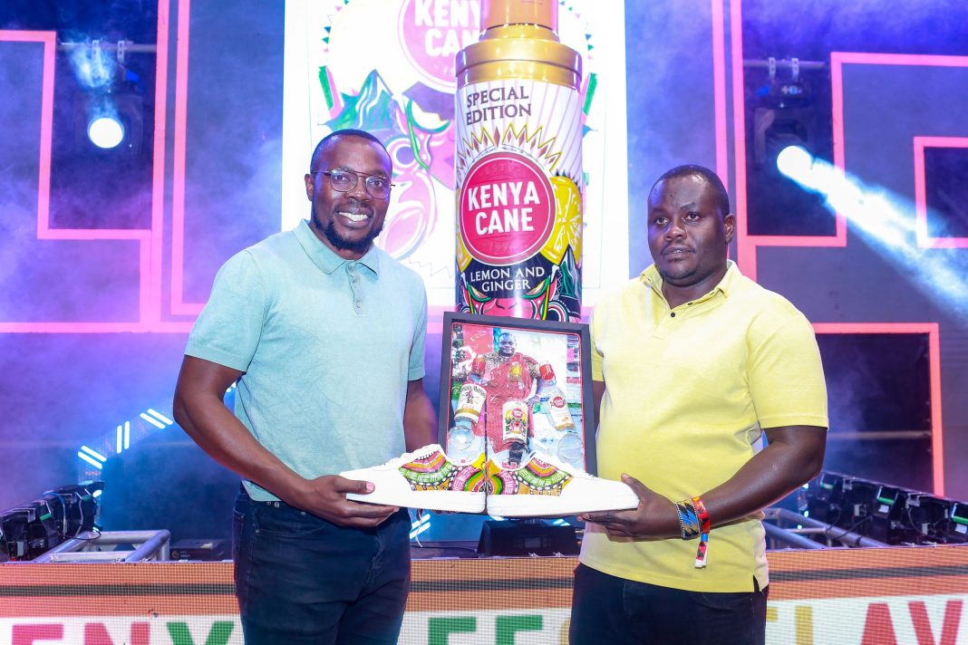 From left Victor Adada - Brand Manager Kenya Cane presenting a gift to Davis Changalwa - Senior Brand Manager EABL