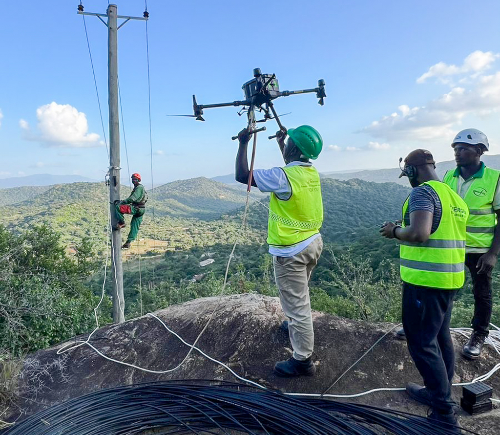A Dronector crew undertakes fibre optic stringing project in a mountainous landscape near Voi.