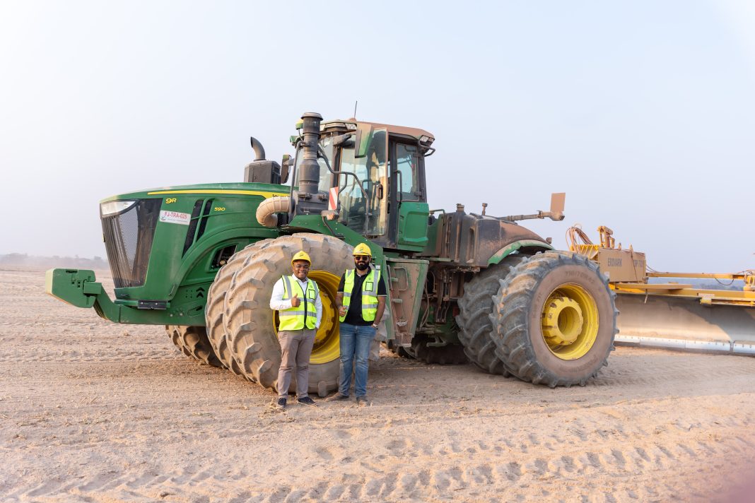 Equity Group EquityBCDC Associate Director for Commercial Projects and Sectors Paty-Paterne Mushagalusa (left) and Jambo Farm Director Vishal Fatania (right) before the levelling tractor.